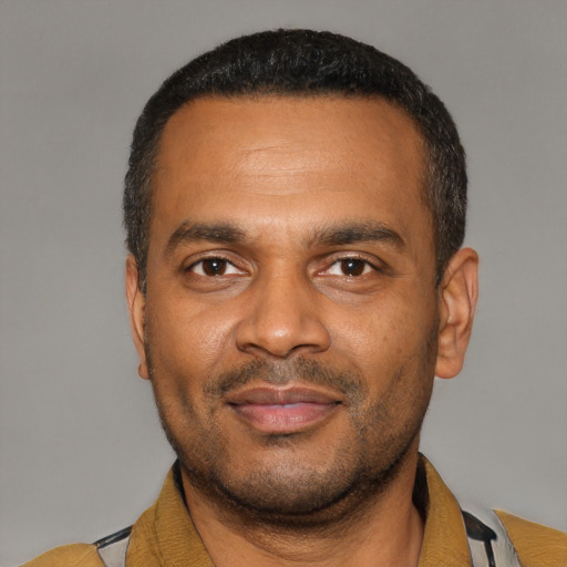 Joyful latino adult male with short  black hair and brown eyes