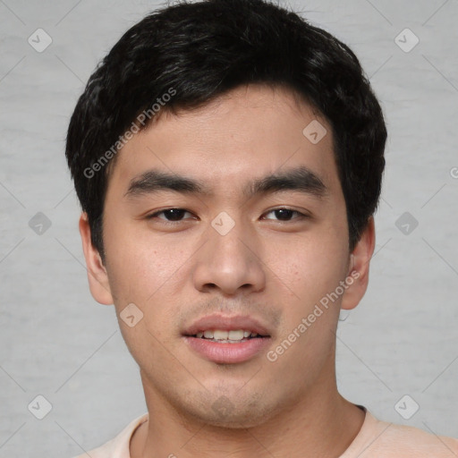 Joyful asian young-adult male with short  black hair and brown eyes