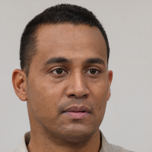 Neutral latino young-adult male with short  brown hair and brown eyes