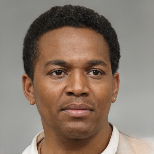 Neutral latino adult male with short  black hair and brown eyes