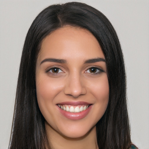 Joyful white young-adult female with long  black hair and brown eyes