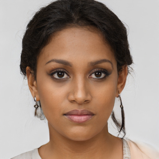 Joyful latino young-adult female with medium  brown hair and brown eyes