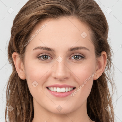 Joyful white young-adult female with long  brown hair and blue eyes