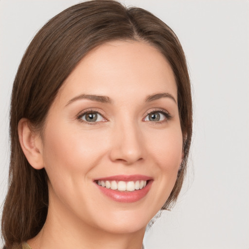 Joyful white young-adult female with medium  brown hair and brown eyes