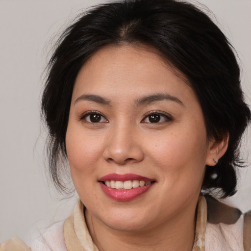 Joyful white young-adult female with medium  brown hair and brown eyes