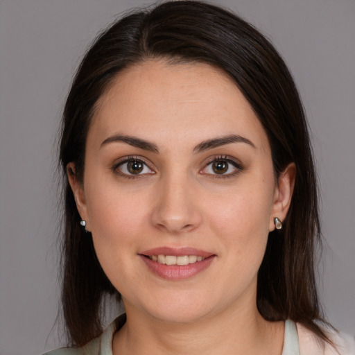 Joyful white young-adult female with medium  brown hair and brown eyes