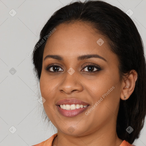 Joyful black young-adult female with medium  brown hair and brown eyes