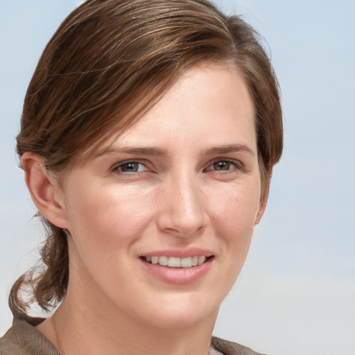 Joyful white young-adult female with medium  brown hair and blue eyes