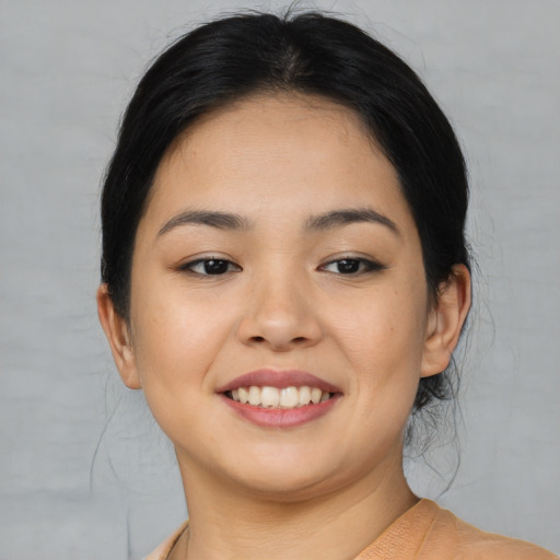 Joyful asian young-adult female with medium  black hair and brown eyes