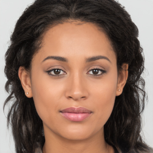 Joyful latino young-adult female with long  brown hair and brown eyes