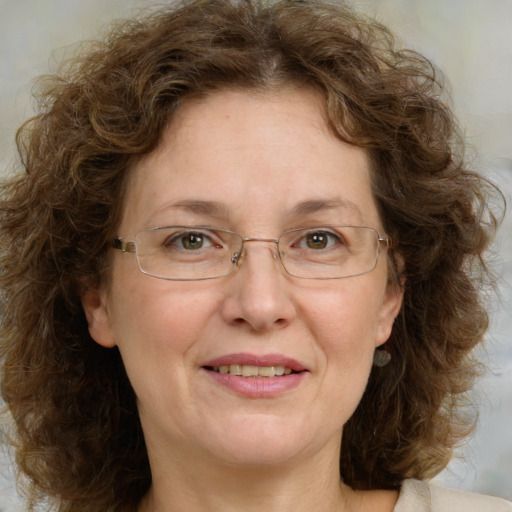 Joyful white adult female with medium  brown hair and green eyes