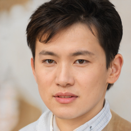 Joyful asian young-adult male with short  brown hair and brown eyes