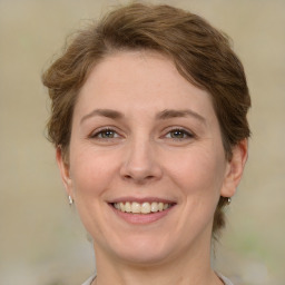 Joyful white adult female with medium  brown hair and green eyes