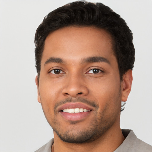 Joyful latino young-adult male with short  black hair and brown eyes