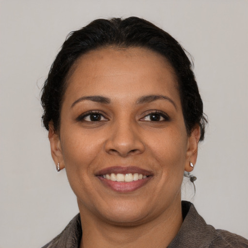 Joyful latino young-adult female with short  brown hair and brown eyes