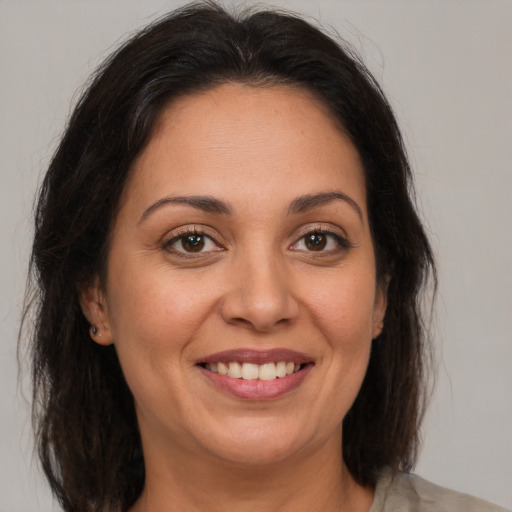 Joyful white adult female with medium  brown hair and brown eyes