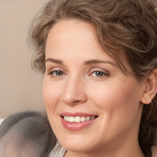 Joyful white adult female with medium  brown hair and brown eyes