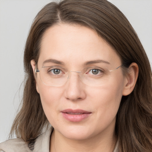 Joyful white adult female with long  brown hair and grey eyes