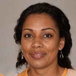 Joyful black adult female with medium  brown hair and brown eyes