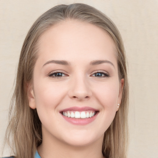 Joyful white young-adult female with long  brown hair and grey eyes