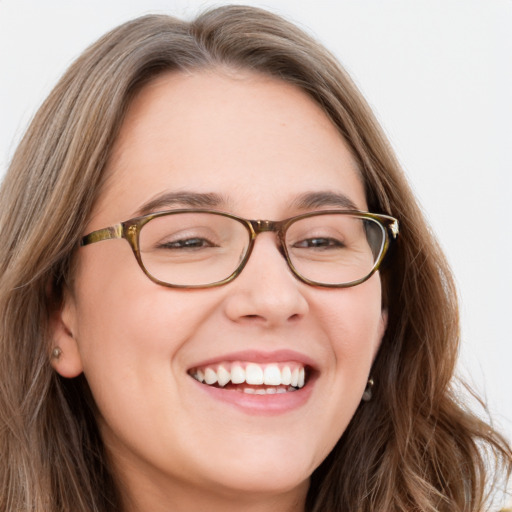 Joyful white young-adult female with long  brown hair and blue eyes