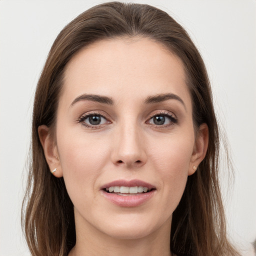 Joyful white young-adult female with long  brown hair and grey eyes