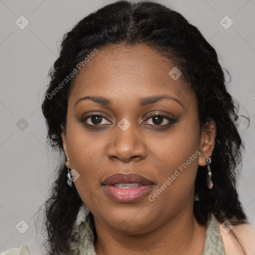 Joyful black adult female with long  black hair and brown eyes