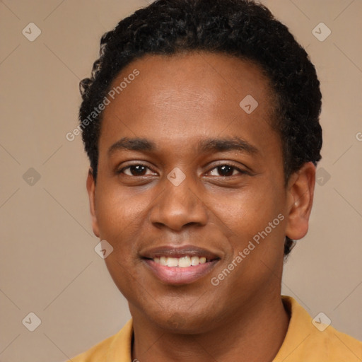 Joyful black young-adult male with short  brown hair and brown eyes