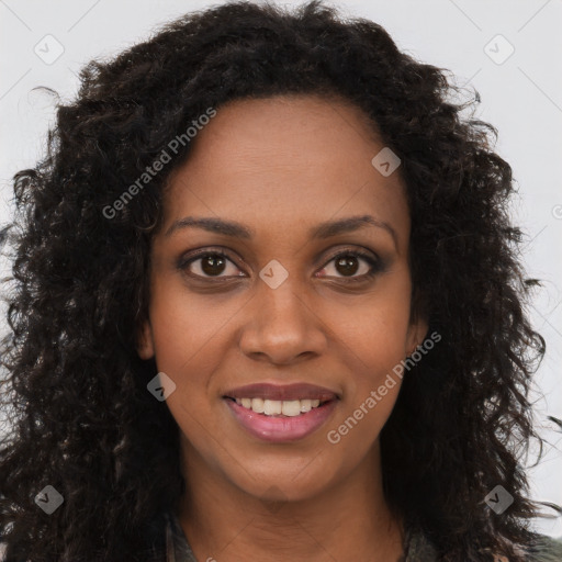 Joyful black young-adult female with long  brown hair and brown eyes