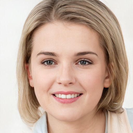 Joyful white young-adult female with medium  brown hair and blue eyes