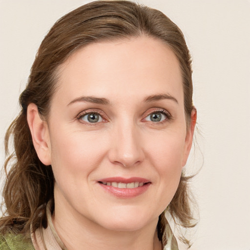 Joyful white young-adult female with medium  brown hair and blue eyes