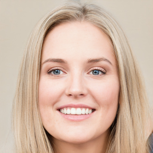 Joyful white young-adult female with long  brown hair and blue eyes