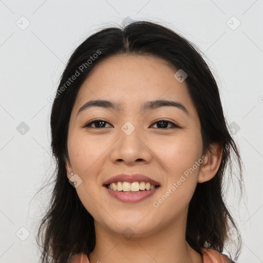 Joyful asian young-adult female with long  brown hair and brown eyes