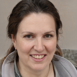 Joyful white adult female with medium  brown hair and brown eyes