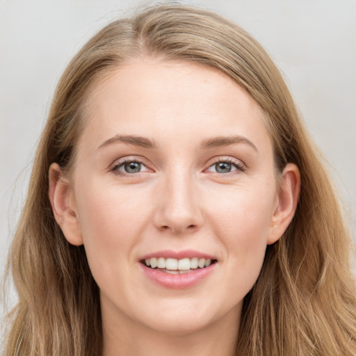 Joyful white young-adult female with long  brown hair and blue eyes