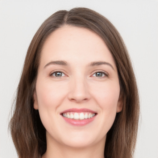 Joyful white young-adult female with long  brown hair and grey eyes