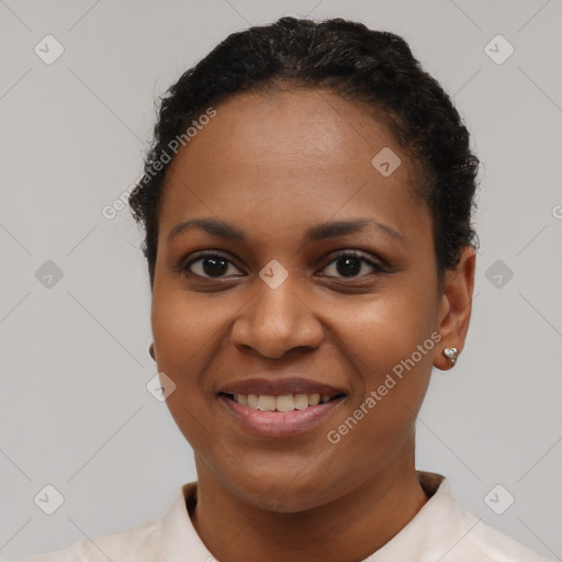 Joyful black young-adult female with short  black hair and brown eyes