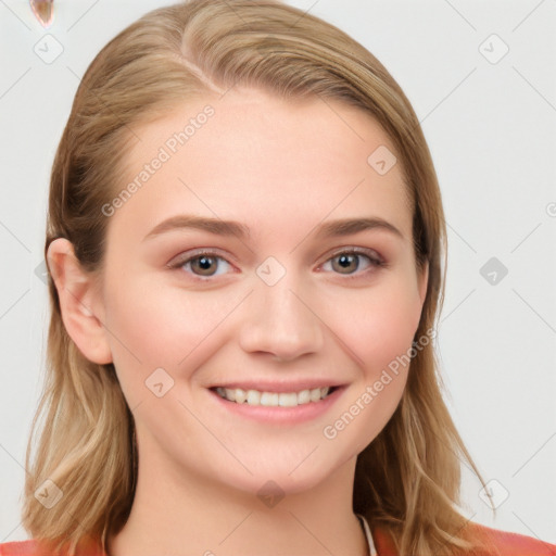 Joyful white young-adult female with long  brown hair and blue eyes