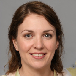 Joyful white adult female with medium  brown hair and grey eyes