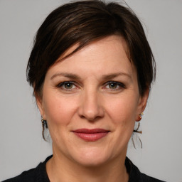 Joyful white adult female with medium  brown hair and grey eyes