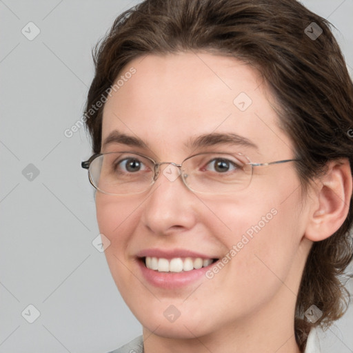 Joyful white young-adult female with medium  brown hair and grey eyes