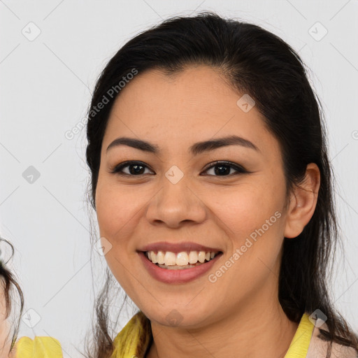 Joyful latino young-adult female with medium  brown hair and brown eyes