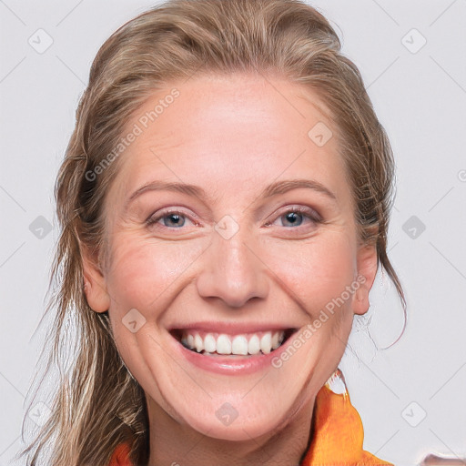 Joyful white adult female with long  brown hair and blue eyes