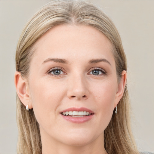 Joyful white young-adult female with long  brown hair and blue eyes