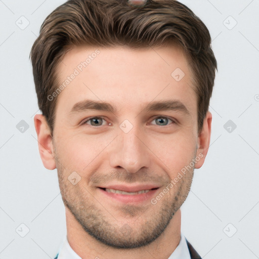 Joyful white young-adult male with short  brown hair and grey eyes