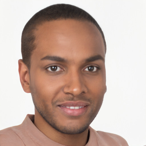 Joyful black young-adult male with short  brown hair and brown eyes