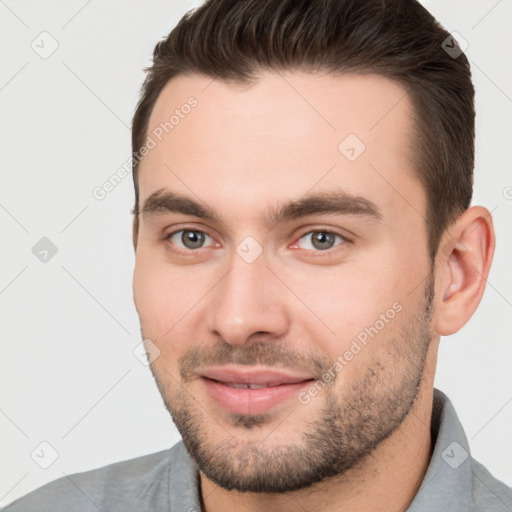 Joyful white young-adult male with short  brown hair and brown eyes