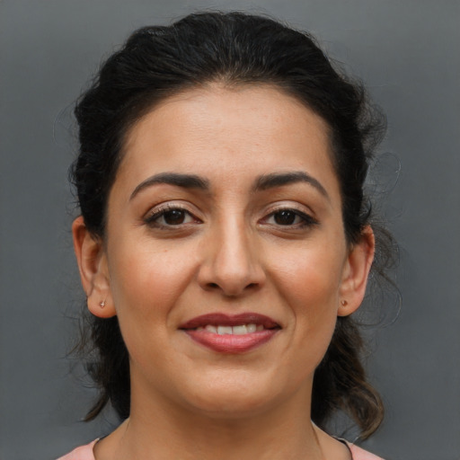 Joyful latino young-adult female with medium  brown hair and brown eyes