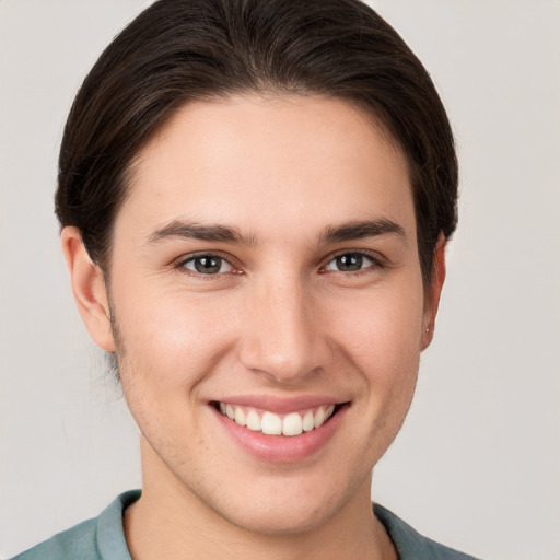 Joyful white young-adult female with short  brown hair and brown eyes