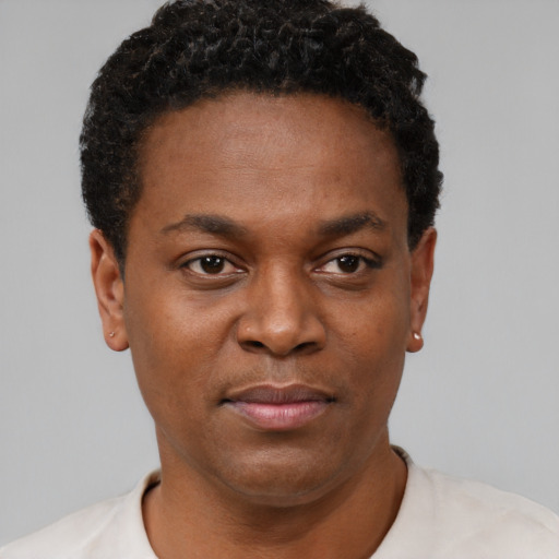 Joyful black young-adult male with short  brown hair and brown eyes